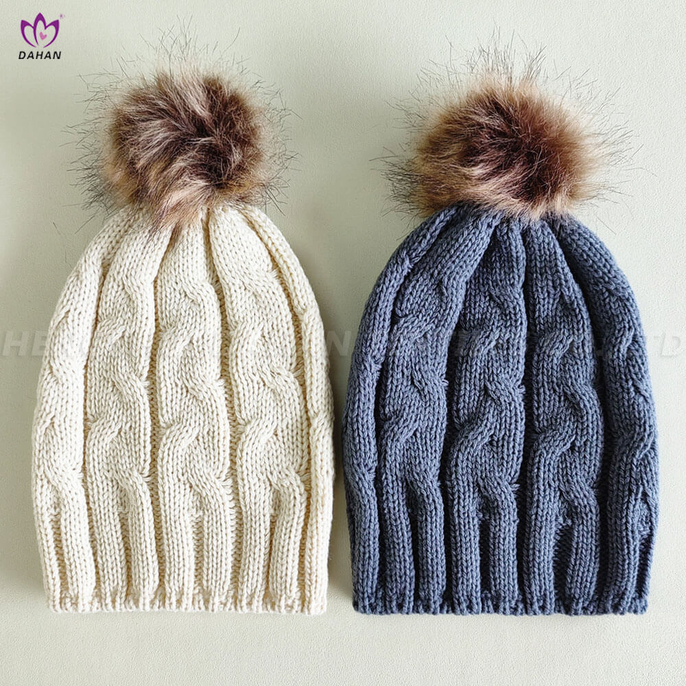 Knitting hat with wool ball.